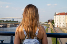 Young Woman Looking At Vistulan Boulevards In Kraków, Around The Vistula River (Wisła). Female Traveler At Popular Recreational Area In Krakow, Poland.