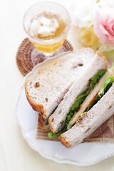 Wall Mural - Homemade swordfish fillet and lettuce sandwiches on dish with copy space