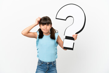 Wall Mural - Little caucasian kid isolated on white background holding a question mark icon and having doubts