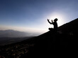 man begging and praying to god on top of mountains