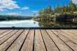 Republic Karelia. Ladoga landscape. Lakes of Russia. Pier next to lake in Karelia. Nature Ladoga blue sky. Republic Karelia on sunny day. Northern nature of Russia. Coniferous taiga on opposite bank