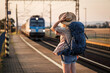 © encierro - Travel by train. Woman backpacker standing at railroad station