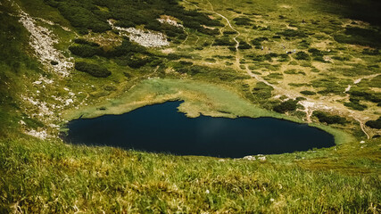 Wall Mural - lake nesamovite and surrounding landscape against background of green mountains