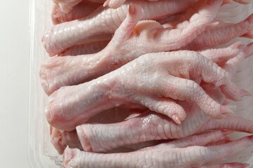 Closeup of raw chicken feet piled on each other