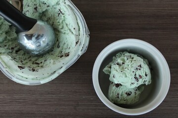 Poster - Top view of scoops of green mint chocolate chip ice cream in the bowl