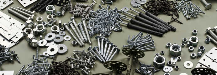 Wall Mural - Set of bolts nuts nails metal fasteners. Consumable hardware tools. assortment steel screws collection close up background