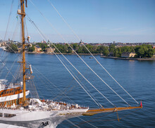 Fore With Bowsprit Of Cruise Sailing Ship And Skyline Of The Old Town Gamla Stan, A Sunny Summer Day In Stockholm
