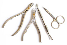 Cuticle Pusher, Cuticle Trimmer. Nail Trimmer And Purpose Scissors Isolated On A White Background. Manicure And Pedicure Nail Care Tools Set. Top View.