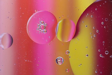 Macro shot of bright pink and yellow bubbles in a liquid