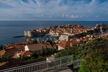 Poster - View of historic coastal old town Dubrovnik with her harbor and rampart all around city. Croatia.