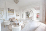 Fototapeta  - snow-white luxury apartment interior with Egyptian-style decor with light stylish furniture. huge panoramic windows and an archway. minimalism and simplicity with the elegance of modern housing design