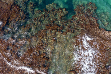 Wall Mural - Aerial view of waves splashing on beach