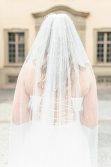 Canvas Print - Vertical shot of a bride standing from behind