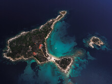 Drone Above Small Island With House, Green Vegetation And Rocky Coastline In The Mediterranean At Chalkidiki Peninsula, Greece