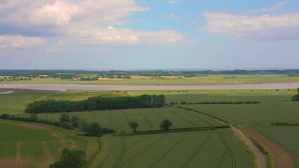 Wall Mural - Aerial drone footage of fields with River Deben in the distance in Suffolk, United Kingdom