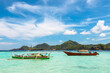 © robertharding - Outrigger canoe and tour boat off Mahoro Island, Pahepa Island beyond, Mahoro, Siau, Sangihe Archipelago, North Sulawesi, Indonesia
