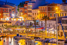 View Of Cafes, Restaurants And Boats In Harbour At Dusk, Cales Fonts, Es Castell, Menorca, Balearic Islands, Spain