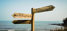 Closeup Shot Of A Beach Sign Showing Directions To Old Harry Rocks On The Isle Of Purbeck, England