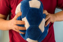 Closeup Shot Of Male Hands Holding A Blue Ball Cushion