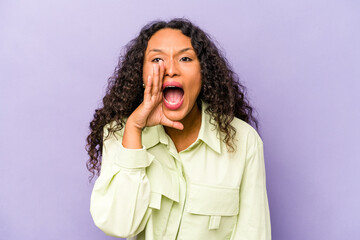 Wall Mural - Young hispanic woman isolated on purple background shouting excited to front.