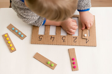 Wall Mural - Insert the appropriate ball strap into the designated numbered slot. Elementary mathematics. A tool for preschool education. Children's Early Learning Montessori Counting Kit.