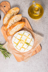 Wall Mural - Baked camembert soft cheese. Grilled brie with toasts and rosemary. 