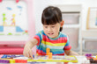 © M-image - young girl play number blocks for homeschooling