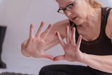 Middle Aged Yogini Researches Mudras In A Downtown Los Angeles Studio.