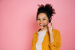 © Kateryna - Happy african american curly haired young woman with headset, help desk worker, call center operator, consultant, talking with client, stand on isolated pink background, looks at camera,smile friendly
