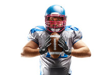 Sport Closeup. Young American Football Player Holding The Ball In His Hands. American Football