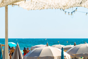 Delightful beach umbrellas on the sea coast on a sunny day.