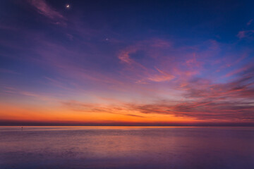 sunset sky with dramatic sunset clouds over the sea. Beautiful sunrise over Ocean