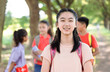 © Tom Wang - Portrait of happy asian young girl outside the primary school