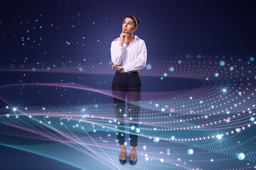Leinwandbilder - Attractive thoughtful young european businesswoman standing on abstract glowing blue metaverse background. Digital world and technology concept.