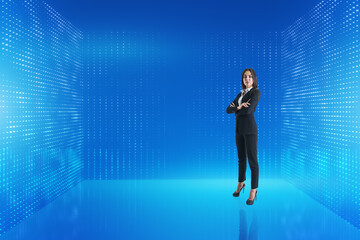 Attractive young european businesswoman standing on abstract glowing blue metaverse background. Digital world and technology concept.