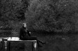 © Сергей Луговский - Young woman on a wooden porch in the middle of the lake in black and white