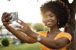 © fotofabrika - Portrait of a young afro american woman taking a selfie outdoor
