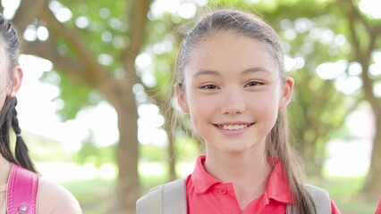 Wall Mural -  Portrait of happy asian young girl and  boy outside the primary school