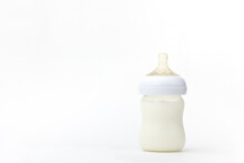Isolated Baby Bottle Feeding Full Of Milk On White Background With Copy Space