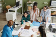 © Seventyfour - Above view of group of female architects discussing new construction project examining blueprint at table at meeting
