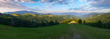 Panorama Of Mountain Landscape In Summertime. Countryside Scenery With Rural Fields On The Forested Hills Rolling In To The Distant Valley. Borzhava Ridge Beneath A Stunning Morning Sky