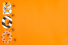 BOO Lettering In Halloween Style. Orange Background And Black Spiders. Place For Text. Copy Space. Halloween Concept. Flay Lay. Top View.