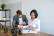 © Julia Jones - A woman and a man are sitting in the office and making notes in a notebook