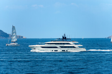 Wall Mural - White luxury yacht and a sailing boat in motion on Mediterranean sea in front of the Palmaria and Tino islands, Porto Venere or Portovenere, Gulf of La Spezia, La Spezia, Liguria, Italy, Europe.