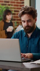Poster - Vertical video: Portrait of business man working on laptop with charts and graphs, using online research data and information to create startup presentation. Planning collaboration project at office