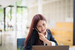 © Jirapong - Asian businesswoman using the phone to contact a business partner