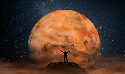 Wall Mural - man observing the mars planet from top of mountain