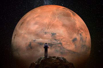 Wall Mural - man observing the mars planet from top of mountain