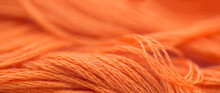 Close Up Of A Skein Of Orange Wool Yarn. Background. Copy Space 