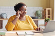 © Seventyfour - Portrait of black young woman doing business while working from home